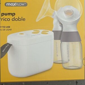 Medela Pump In Style with extra parts and bottles